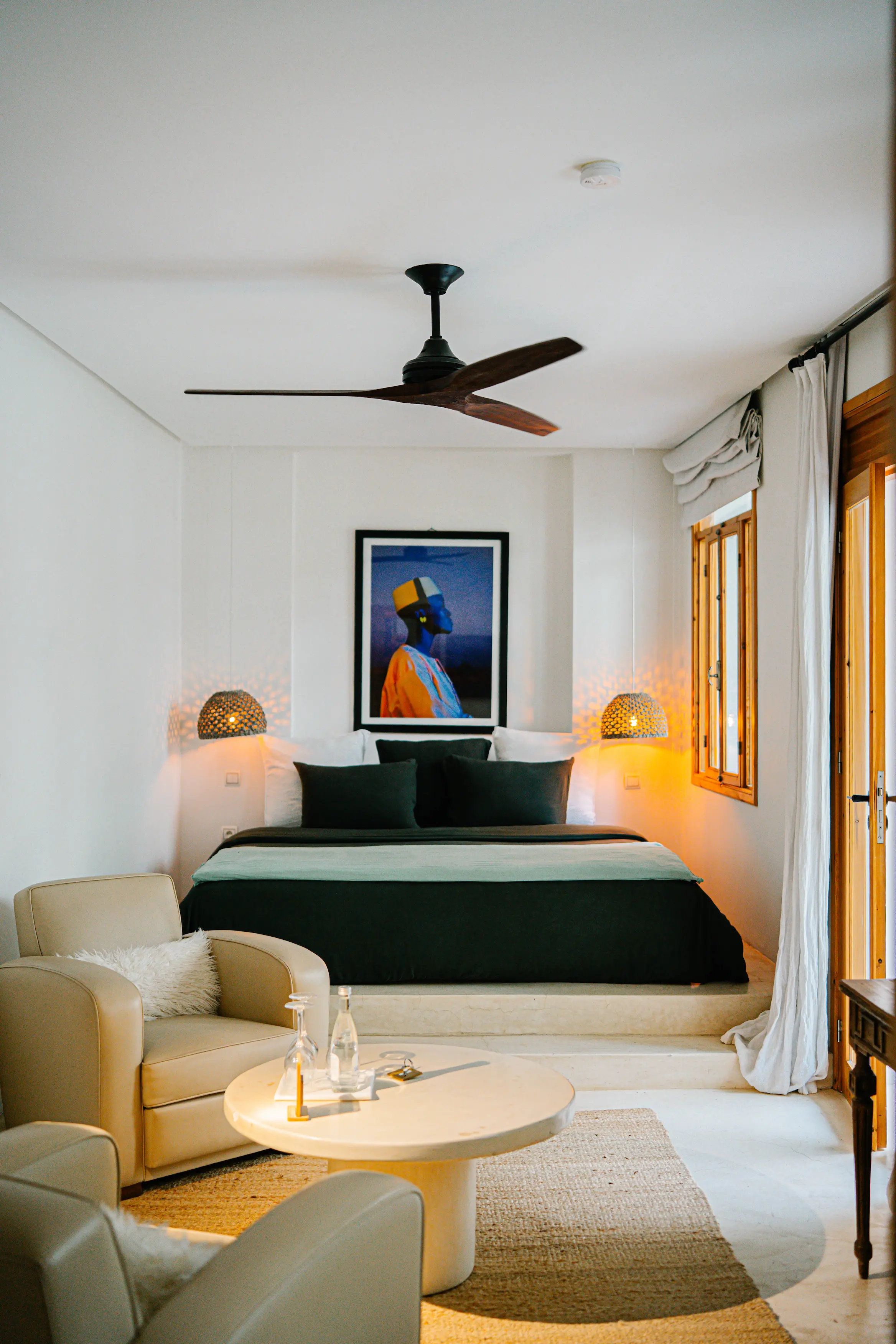 Lush tropical plants and banana trees filling the sunlit courtyard of Pure House, showcasing biophilic design in a Moroccan hotel Lush tropical plants and banana trees filling the sunlit courtyard of Pure House, showcasing biophilic design in a Moroccan hotel