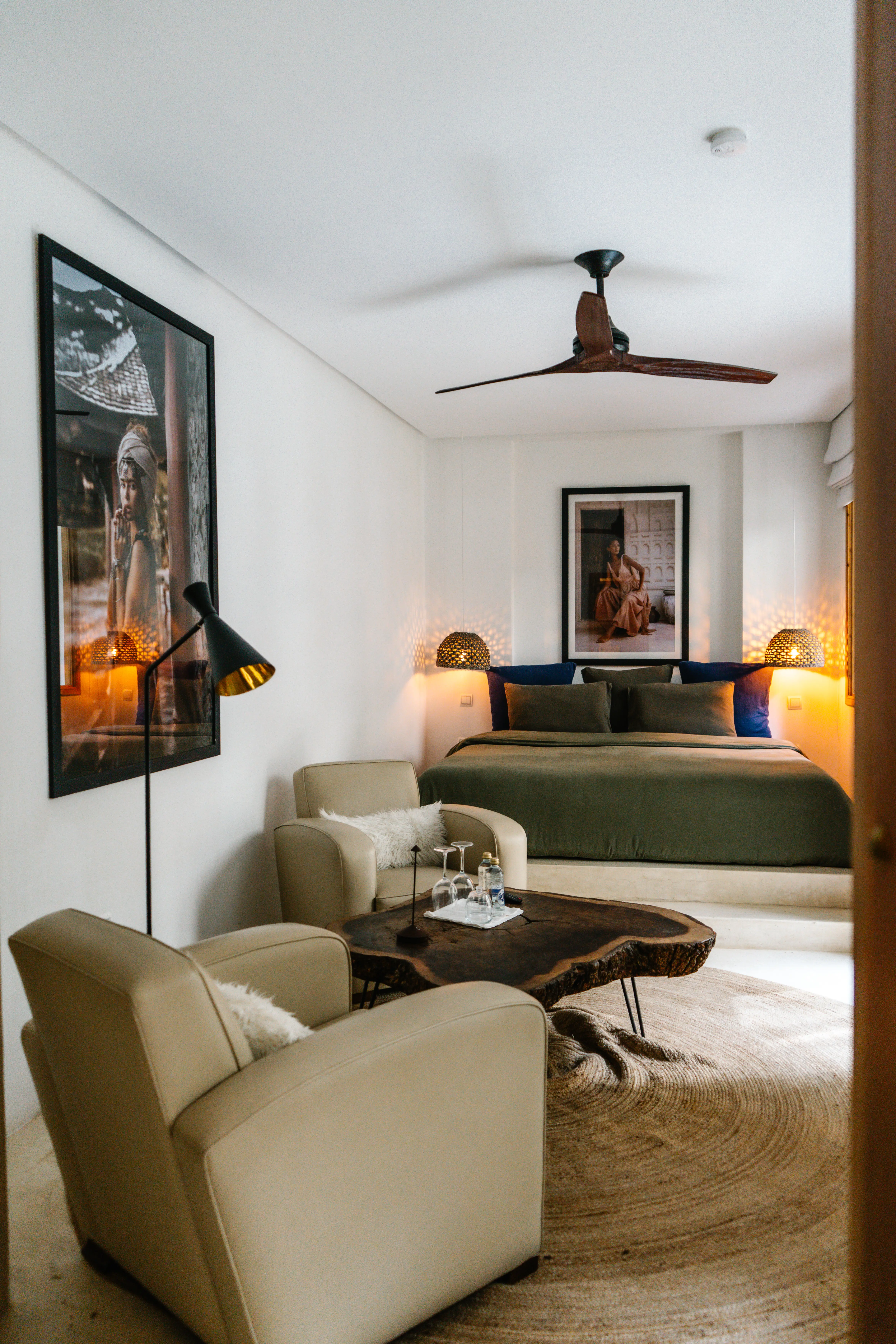 Luxury boutique hotel room featuring a plush bed and sitting area, designed for discerning travelers seeking a peaceful stay in Morocco.