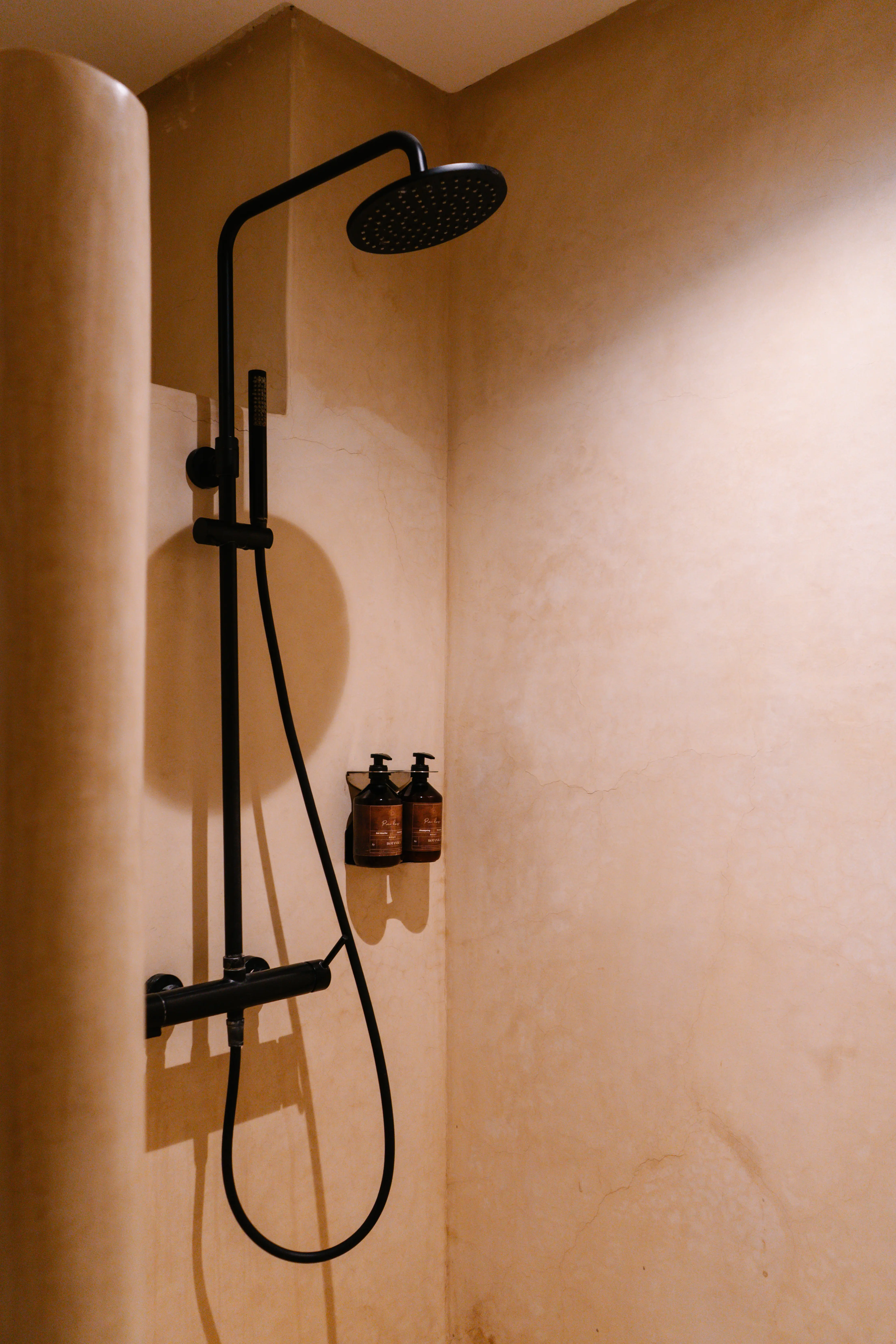 Luxury walk-in shower featuring high-end wellness amenities, minimalist design, and traditional Moroccan tadelakt walls. Luxury walk-in shower featuring high-end wellness amenities, minimalist design, and traditional Moroccan tadelakt walls.