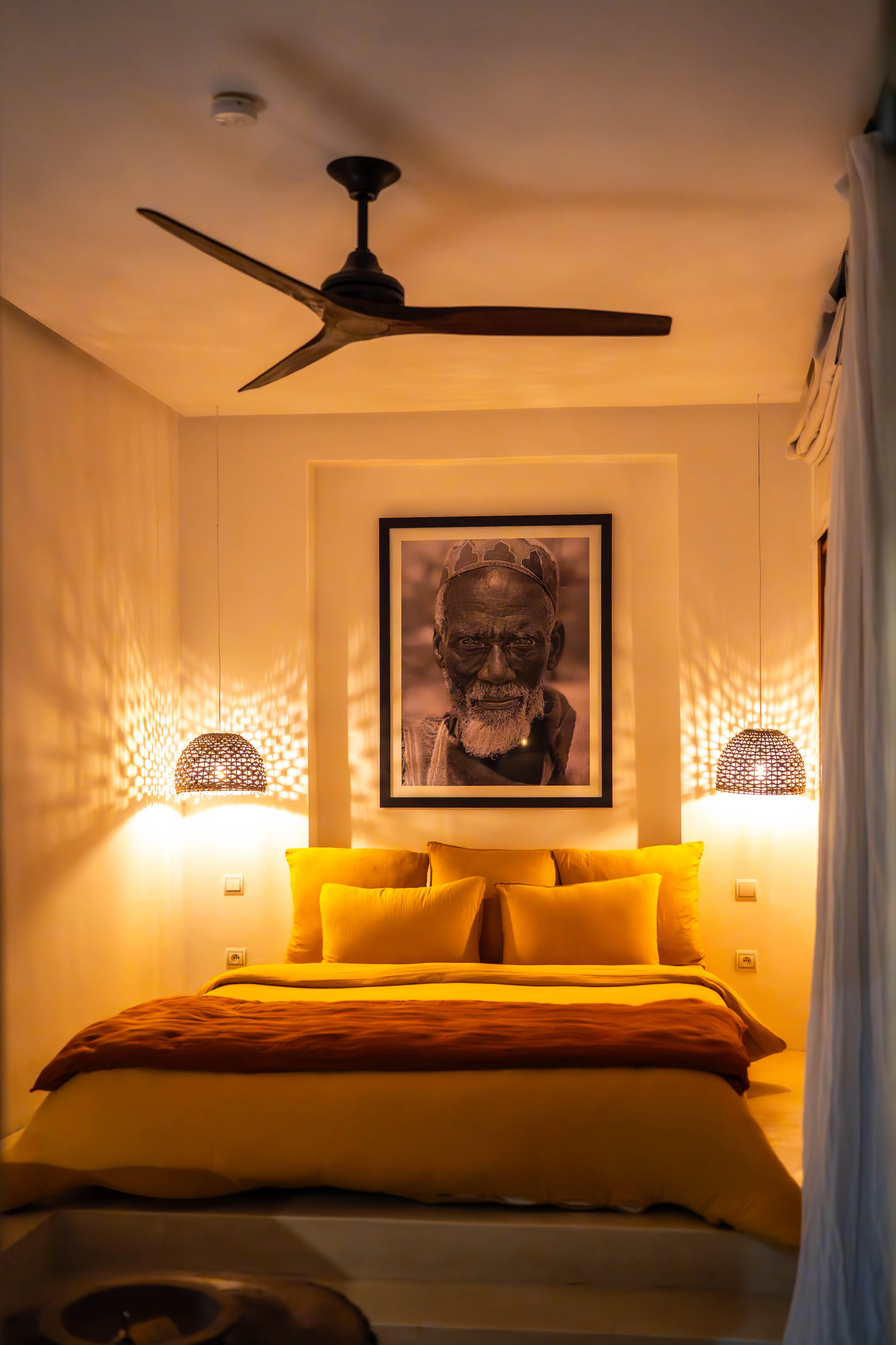 Warmly lit boutique hotel room at Pure House Marrakech, focusing on premium room amenities, ultimate comfort, and romantic aesthetics.