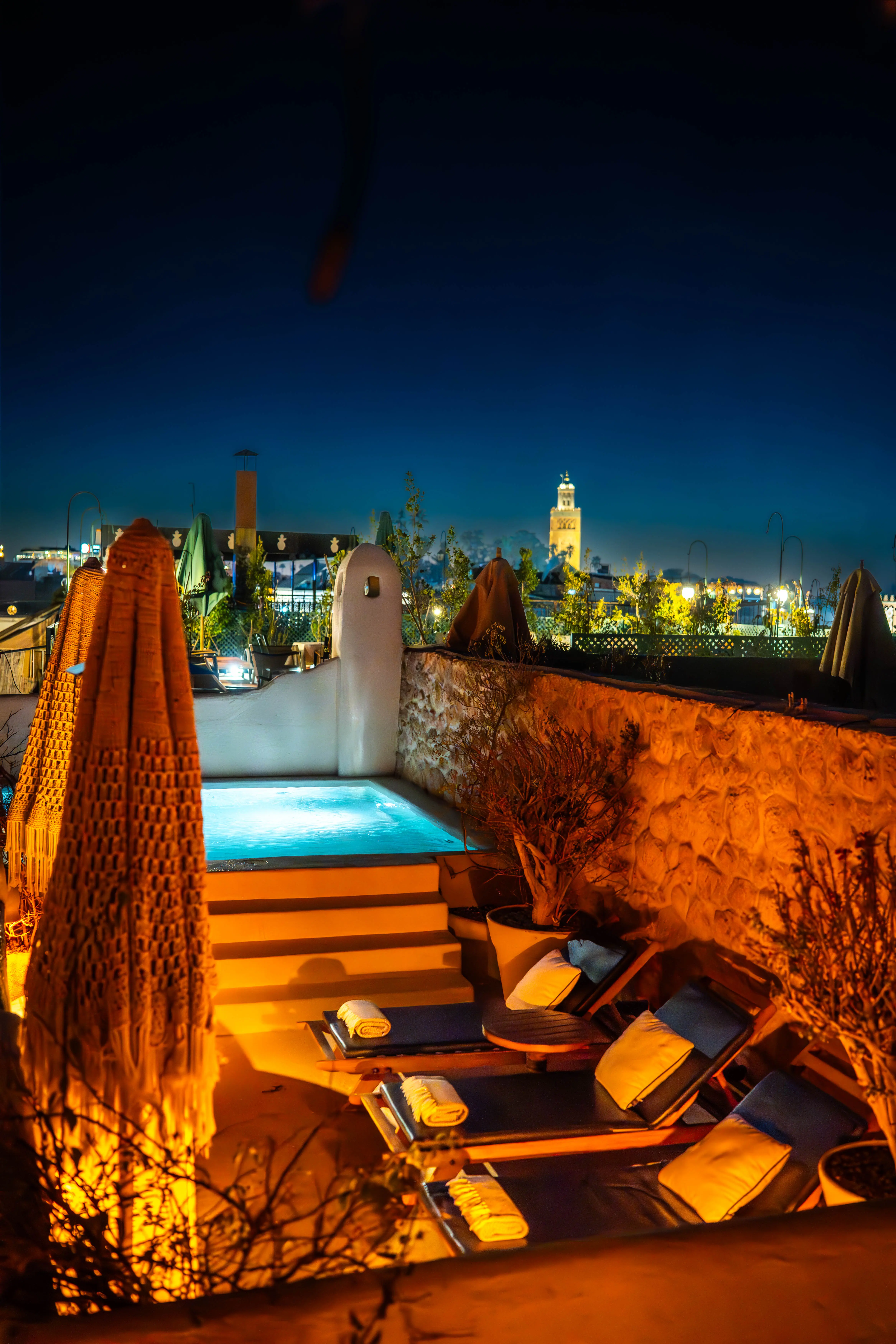 Peaceful rooftop pool and yoga space illuminated at night, creating the ultimate romantic and serene spot in the Marrakech Medina. Peaceful rooftop pool and yoga space illuminated at night, creating the ultimate romantic and serene spot in the Marrakech Medina.