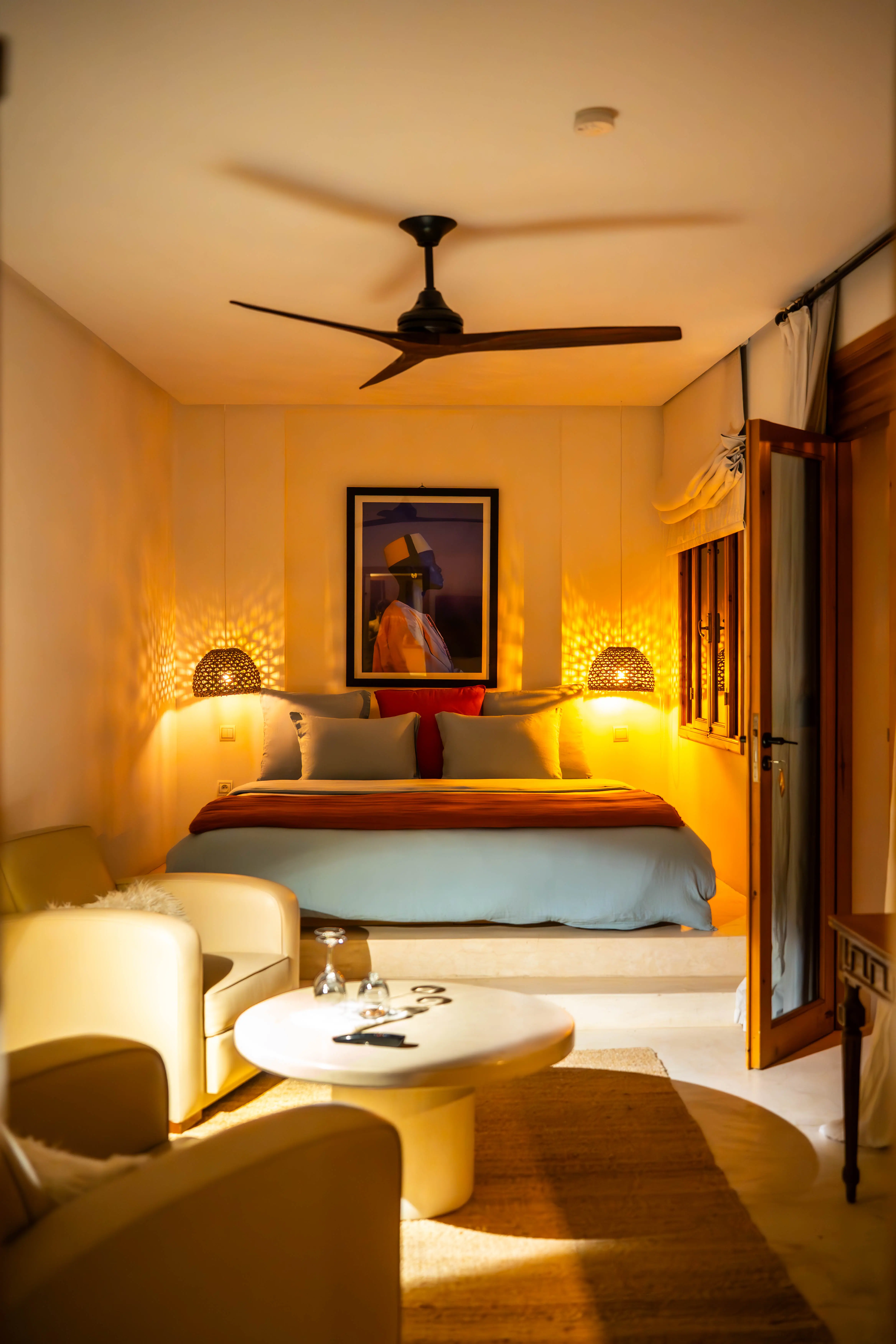 Close-up of a luxurious grand bed with warm lighting, highlighting the romantic and peaceful atmosphere of this adults-only riad.