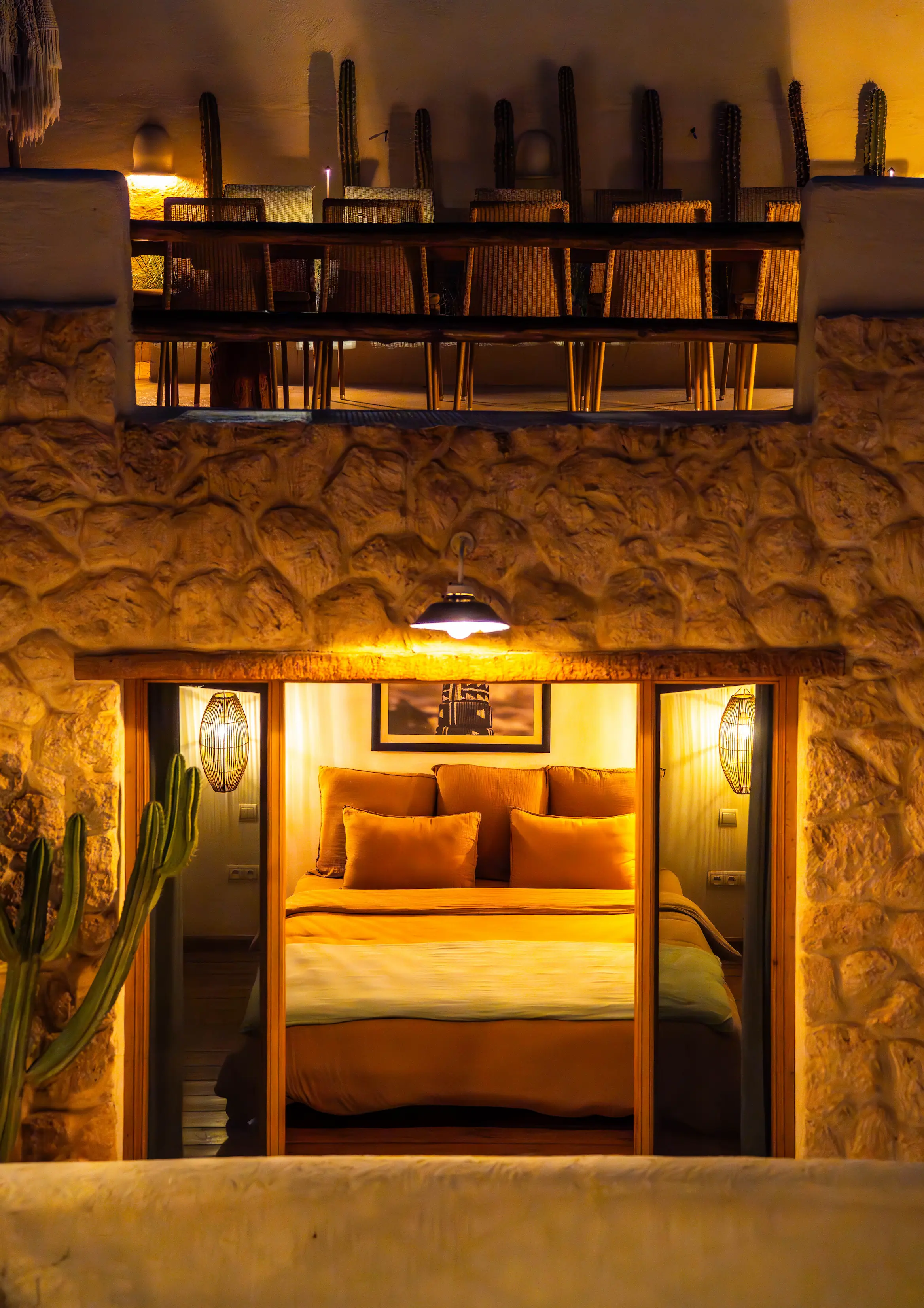 Romantic bedroom view from the courtyard at night, featuring warm ambient lighting for an intimate couples stay