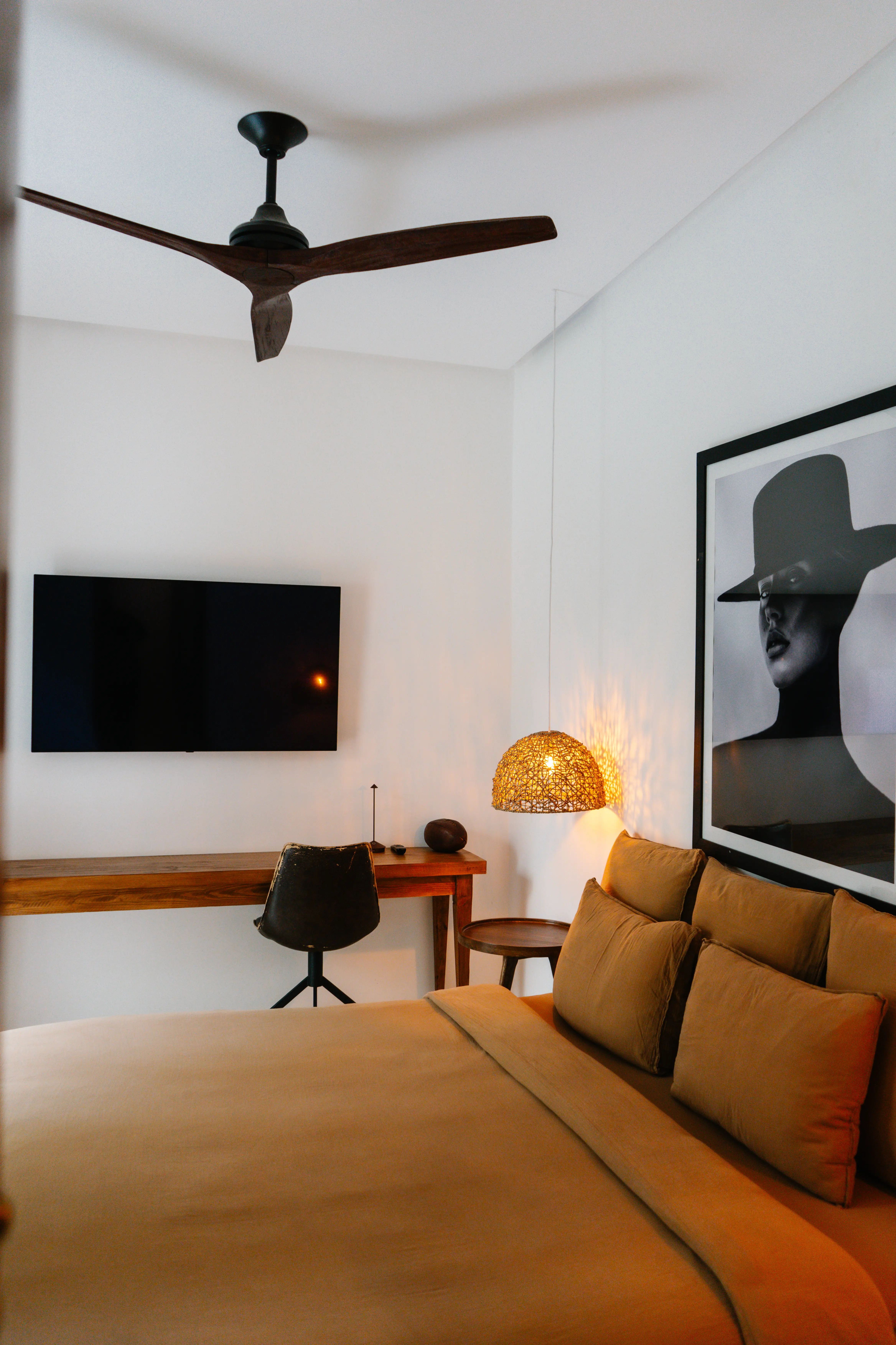 Stylish guest room featuring a comfortable bed and a work desk for the modern discerning traveler